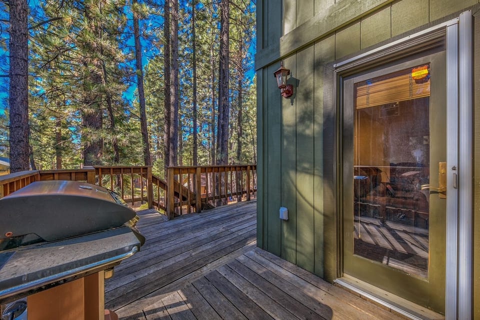 Step onto your private deck where towering pines frame your mountain retreat and the BBQ awaits your evening cookout.