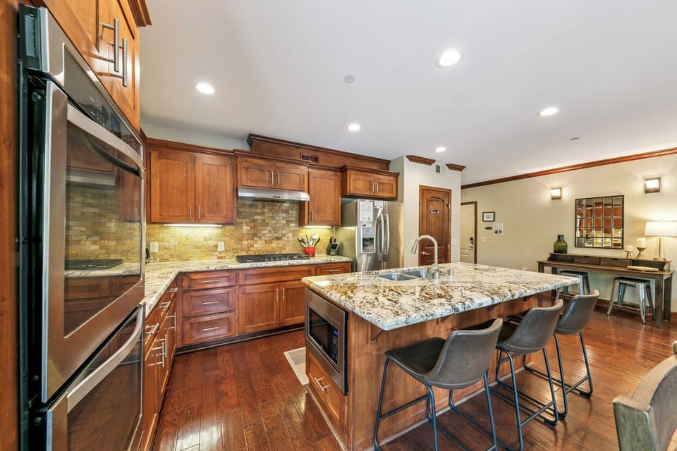 Your gourmet kitchen features granite countertops, stainless appliances, and a spacious island perfect for cooking memorable meals together.