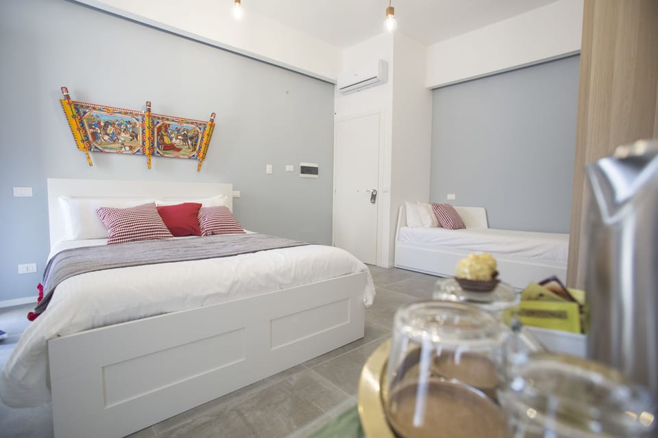 Deluxe Triple Room, Accessible, City View | In-room safe, desk, soundproofing, iron/ironing board