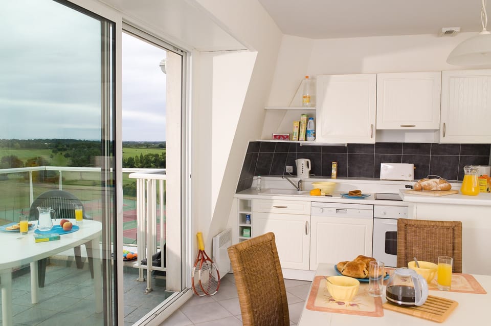 Prepare meals in the kitchenette and enjoy them at the dining table.