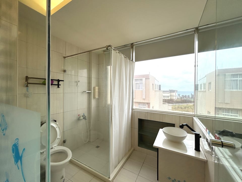 Double Room, Partial Ocean View | Bathroom | Shower, hair dryer, slippers