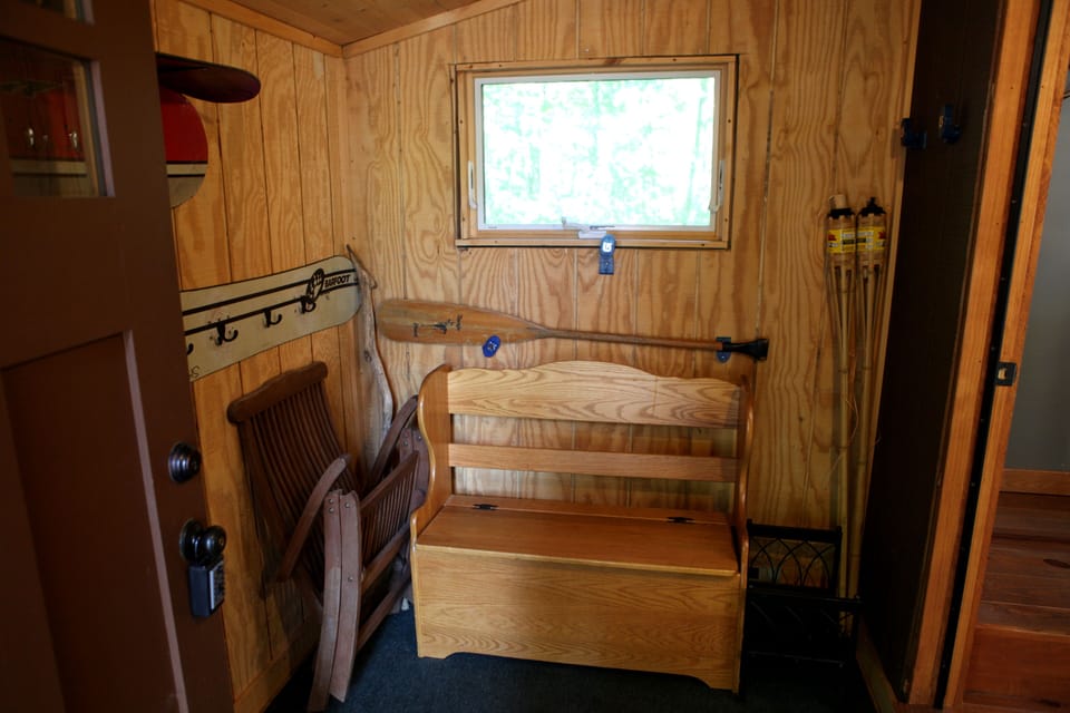Entryway - storage for winter gear and sports equipment with coat hooks.