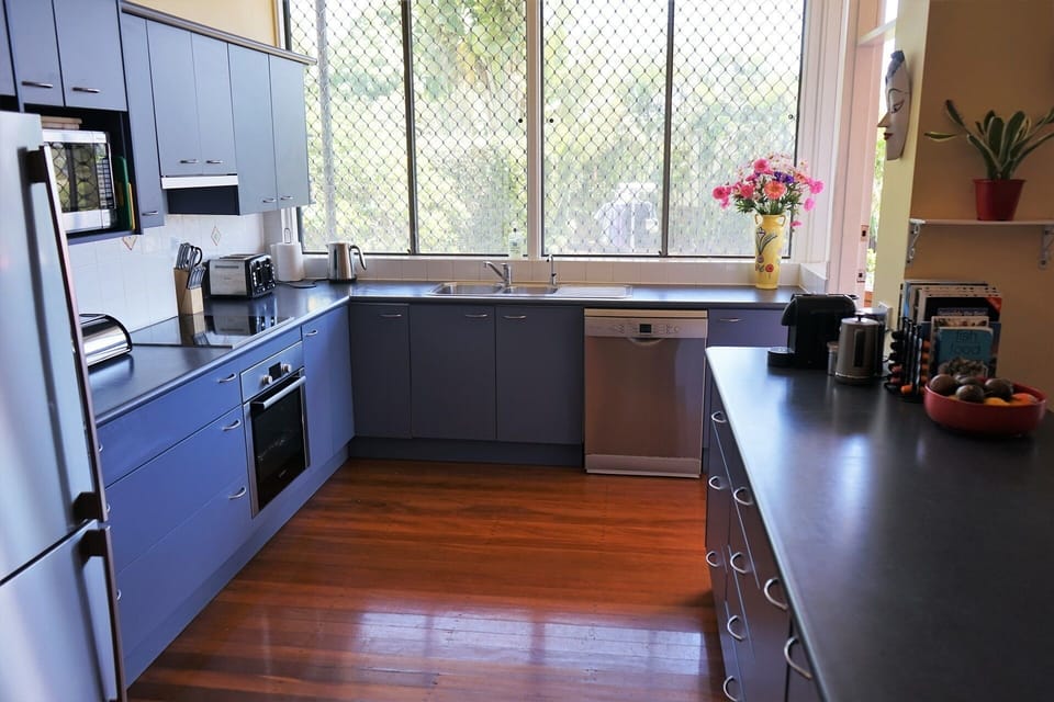 The kitchen overlooks the back yard and opens onto the dining terrace