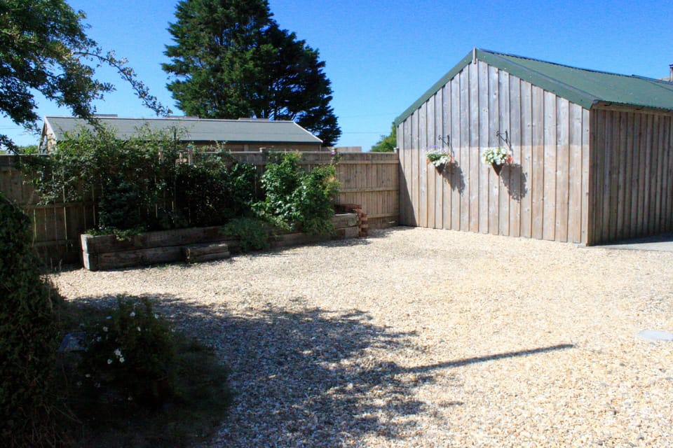 Private area in front of East Woolley Barn with parking to the right