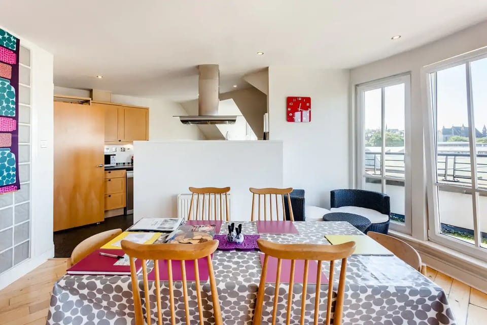 Dining table and open plan kitchen. 