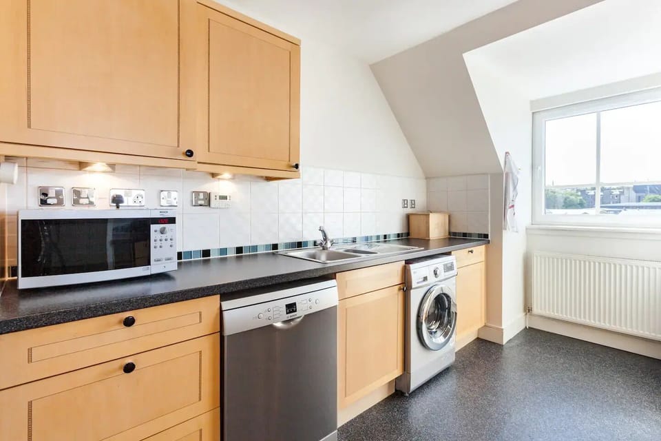 The kithcen includes a microwave, dishwasher and washing machine.