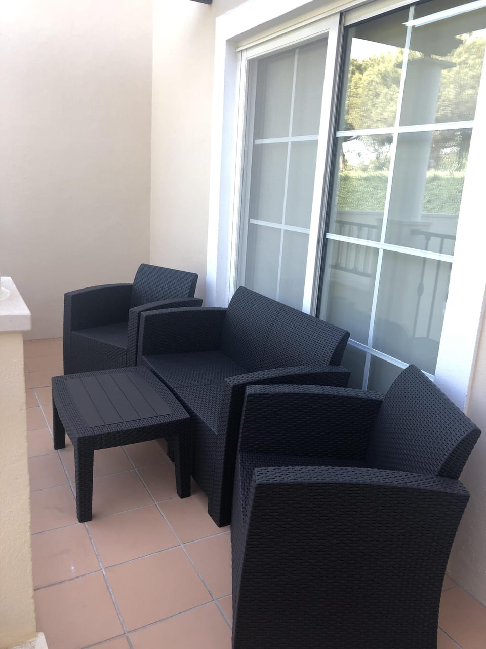 A lovely seating area at the back of the apartment . lovely for evening shade 