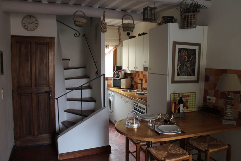 Dining area and kitchenenette, entrance door and stairs up to second level