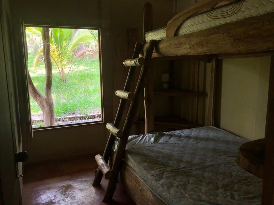 Bunkroom features double bottom bunk and single top bunk. 