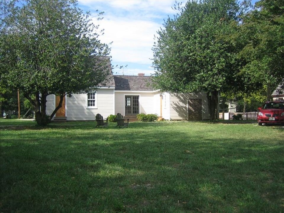 South side of house with patio in center section. Patio faces large open area. 