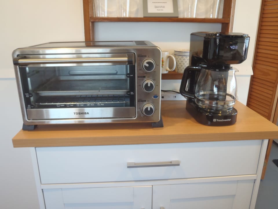Modern counter top appliances include an oversized toaster oven & coffee maker