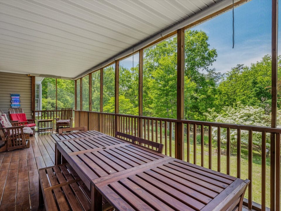 Screened in back porch has dining table and seating area for pest free entertaining.