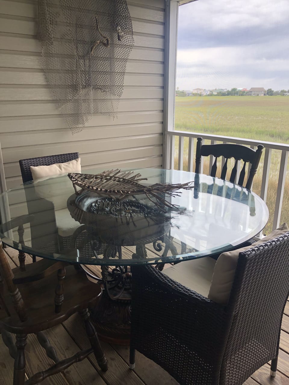 Outdoor eating with a view on the back screened in porch