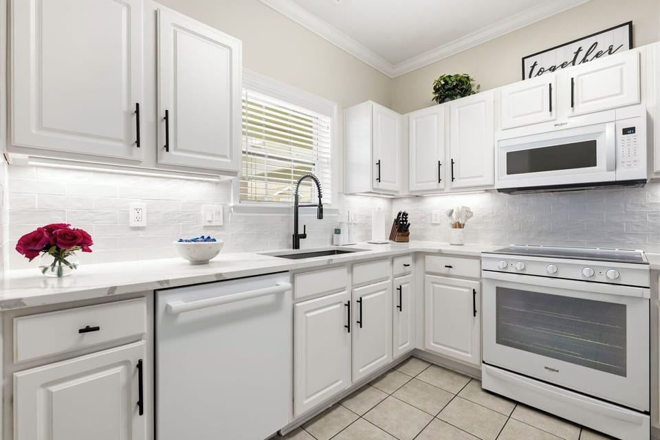 Fully renovated kitchen with quartz countertops and stainless appliances