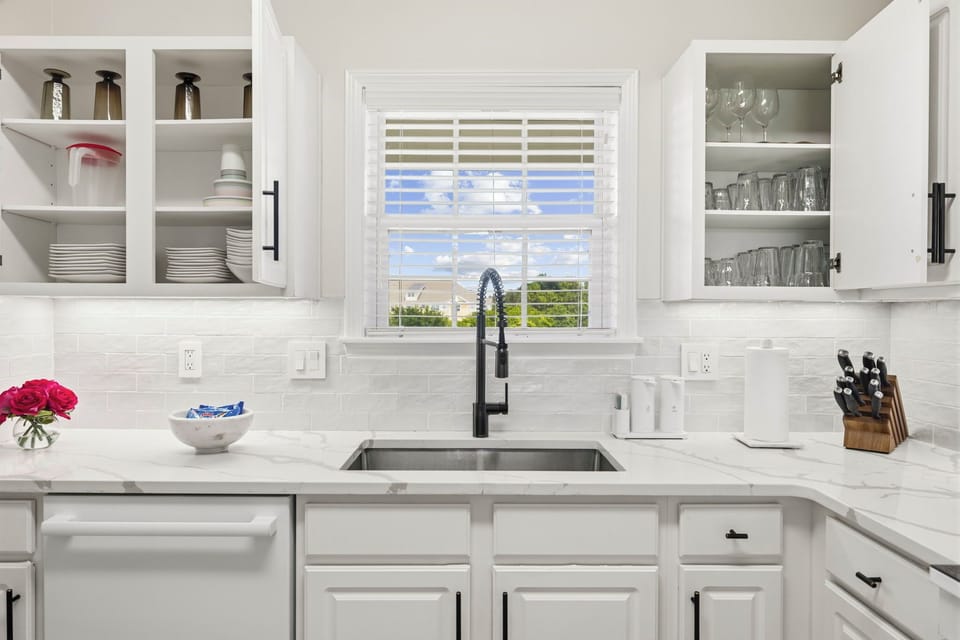 Bright, fully equipped kitchen with large window