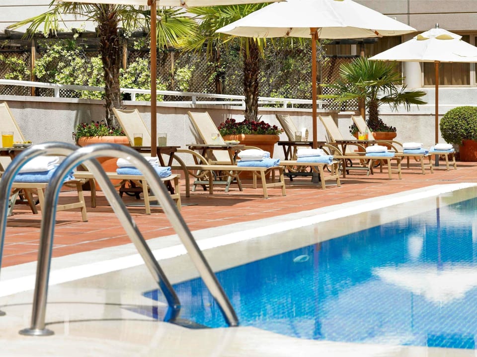 Seasonal outdoor pool, open noon to 8:00 PM, pool umbrellas