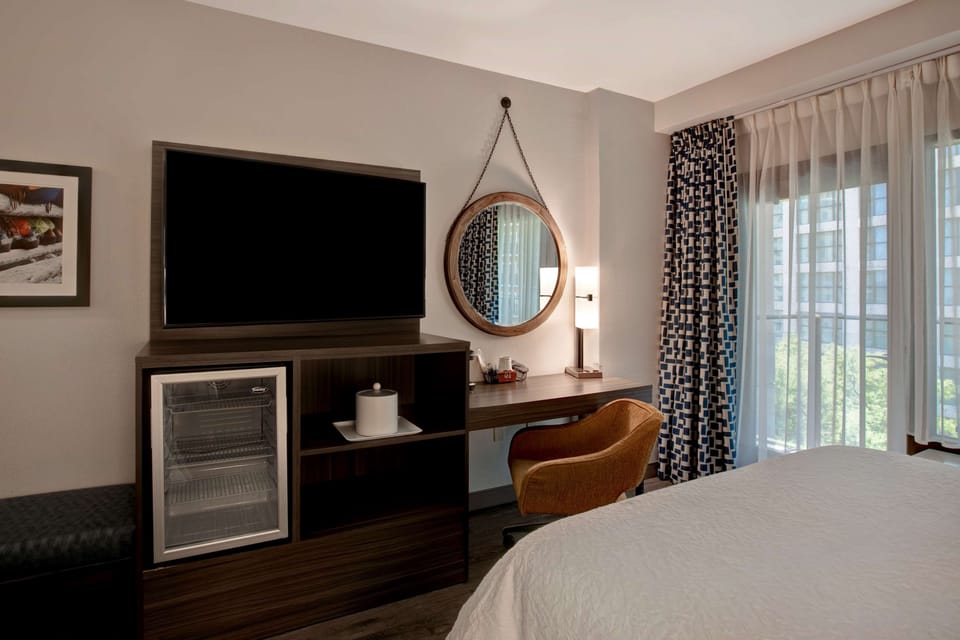 Hypo-allergenic bedding, desk, laptop workspace, blackout drapes