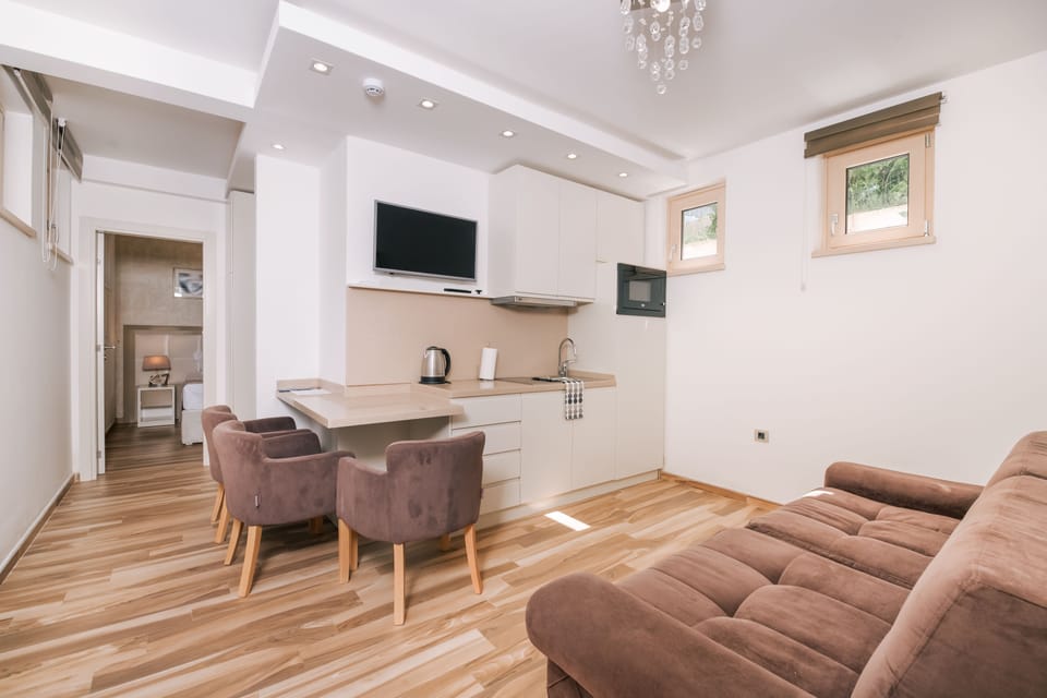 Deluxe Apartment (Ground Floor) | Living area | 81-cm LCD TV with cable channels, TV