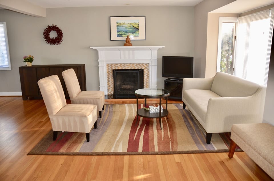 Bright and open living room, furnished with new furniture and original art work