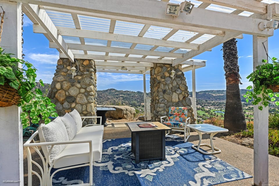 Pool sitting area with an outdoor shower and a nice fireplace. Enjoy the breeze!