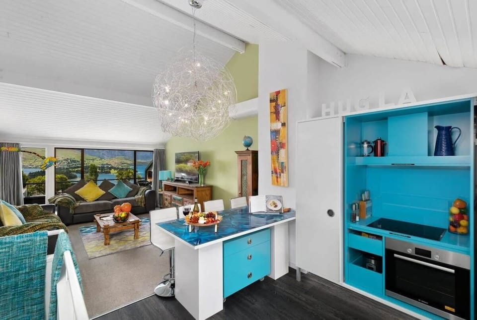 Lounge & Kitchen: Bright, modern space with stunning views and a splash of vibrant decor!