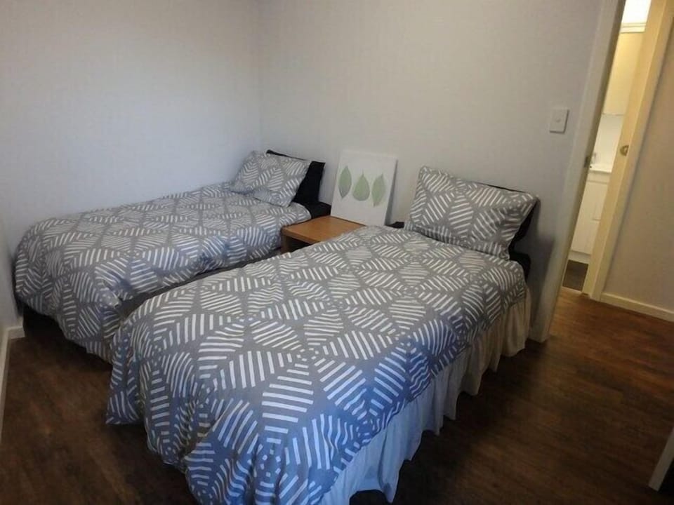 Two single beds, a third full sized mattress on the floor for the fifth guest