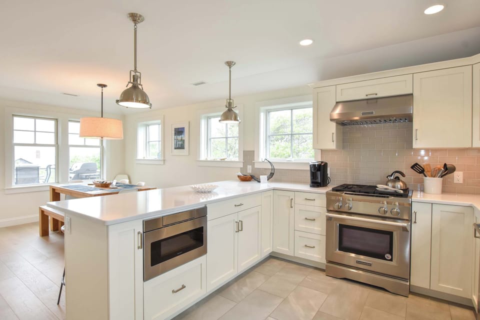 kitchen with counter space, white cabinets and stainless steal appliances