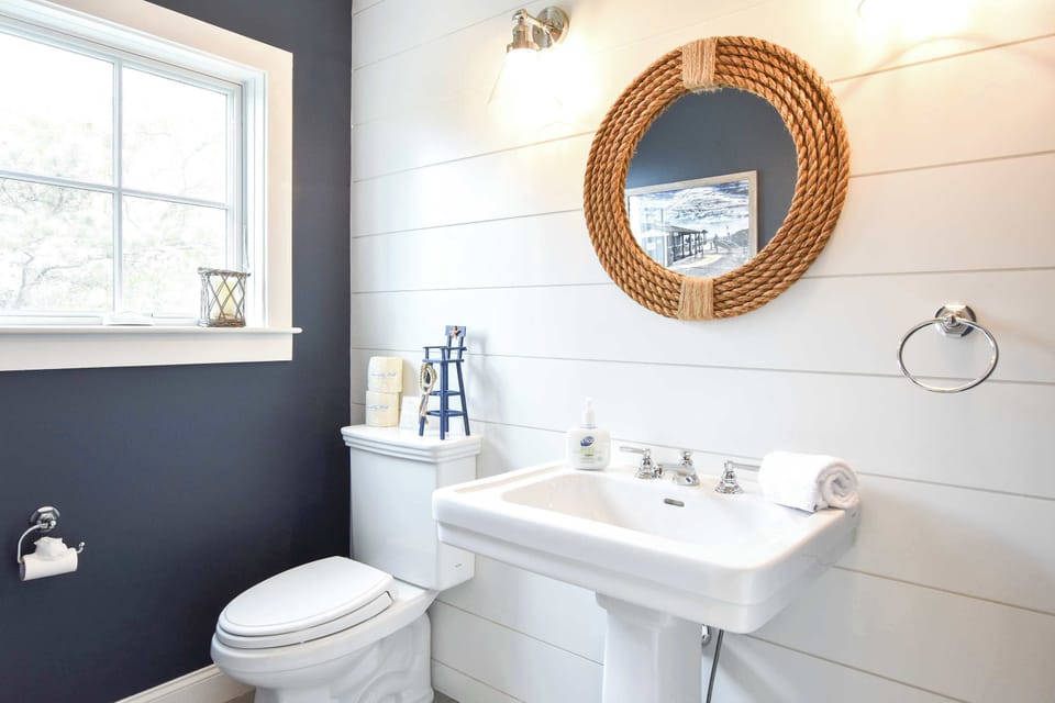 vanity, mirror, and toilet in bathroom