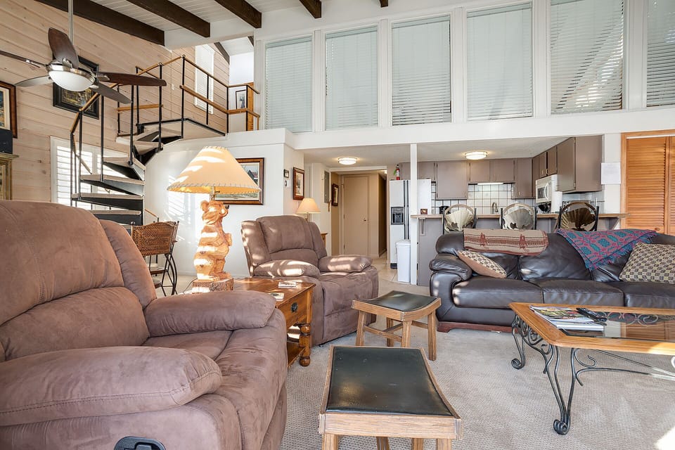 Unwind in your spacious two-story retreat with plush seating, rustic wood beams, and an open loft design perfect for relaxing.