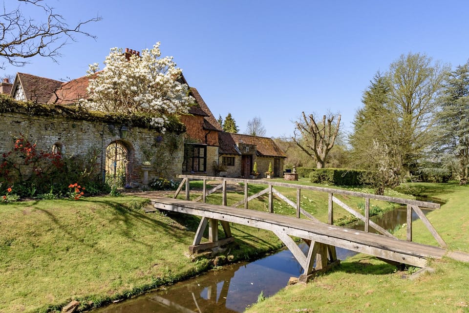Access to the house via single handrail bridge over the moat