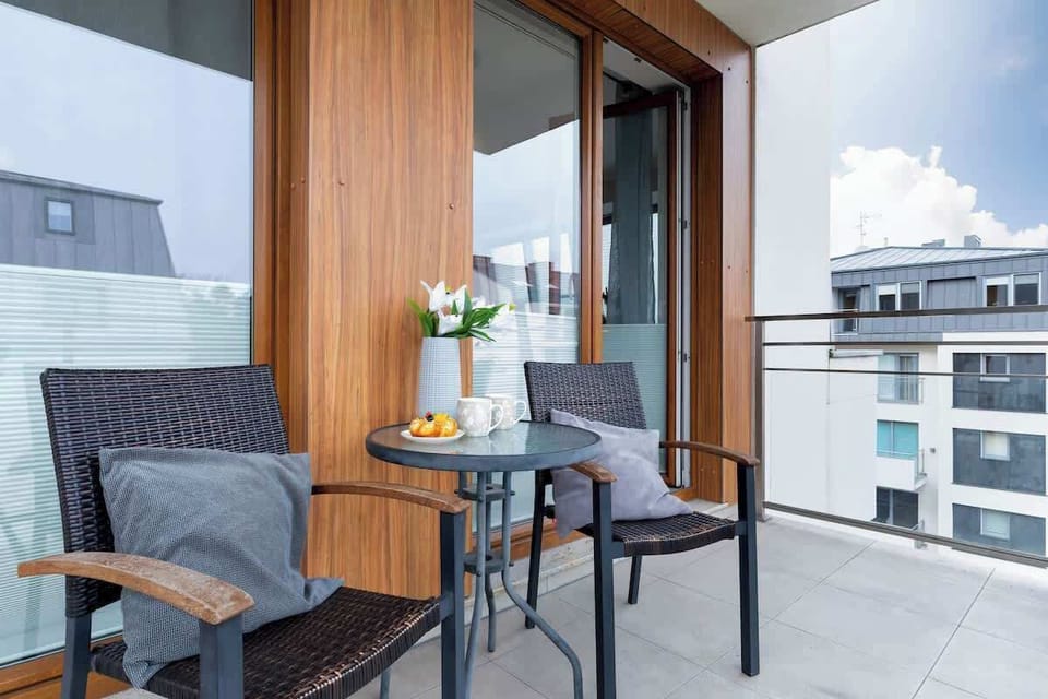 Spacious balcony with outdoor furniture. 