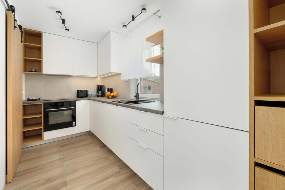 The bright kitchen with full equipment and plenty of counter space ensures convenience while preparing meals.