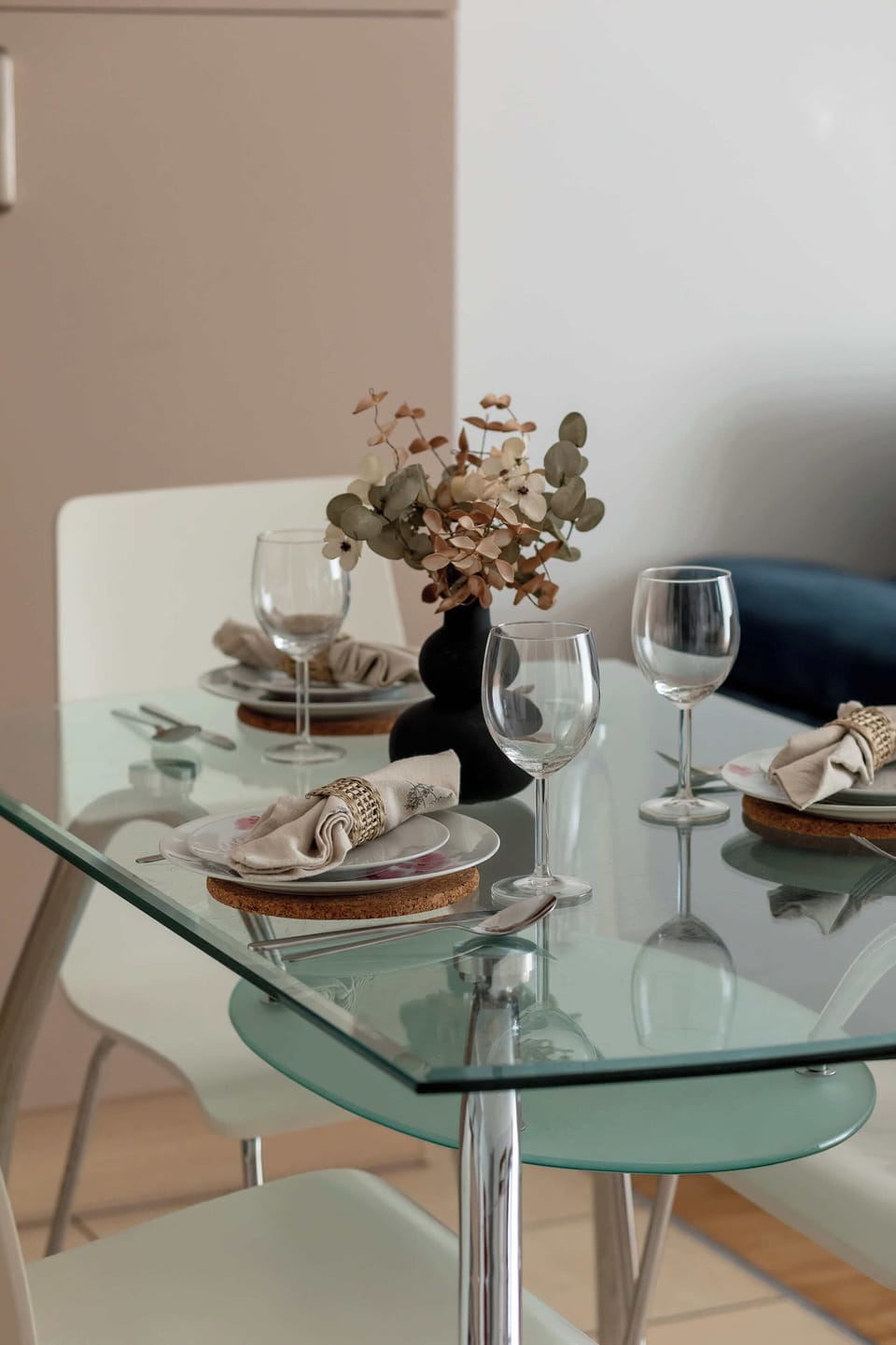 A small dining table setup with plates and decorative items. It creates an intimate dining atmosphere.