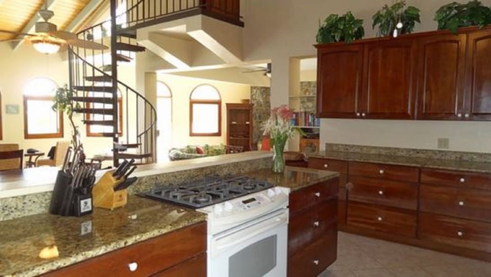 In kitchen looking toward entryway+up curved staircase to Bedroom suite #3 