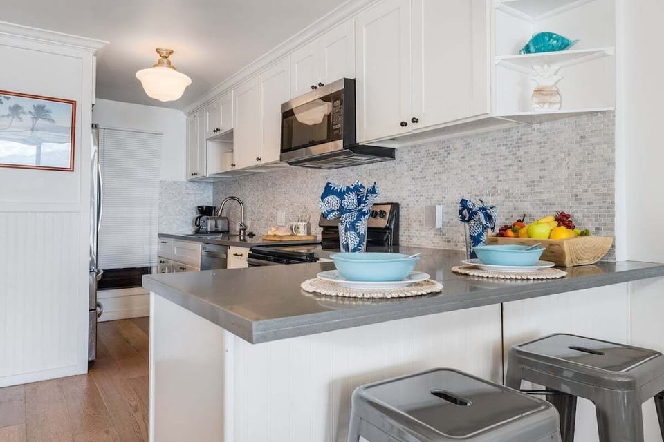 Bright modern kitchen featuring stainless‑steel appliances, ample prep space, and coastal accents