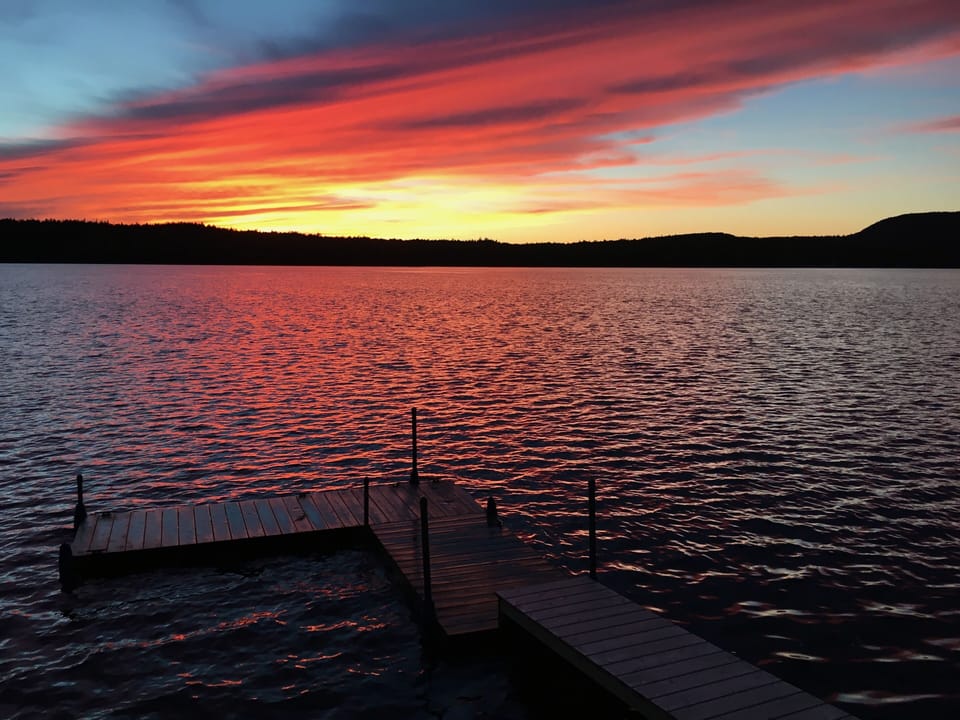 Dock, lake, and sunset
