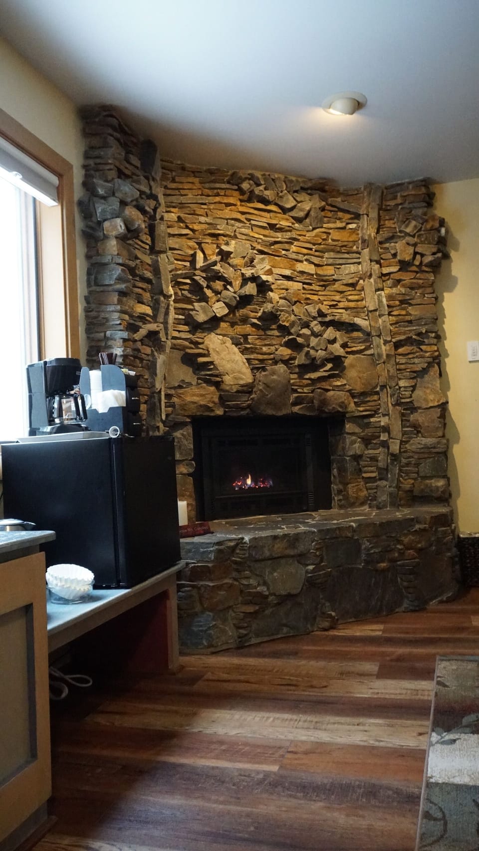 Gas fireplace with custom rock design of aspen trees