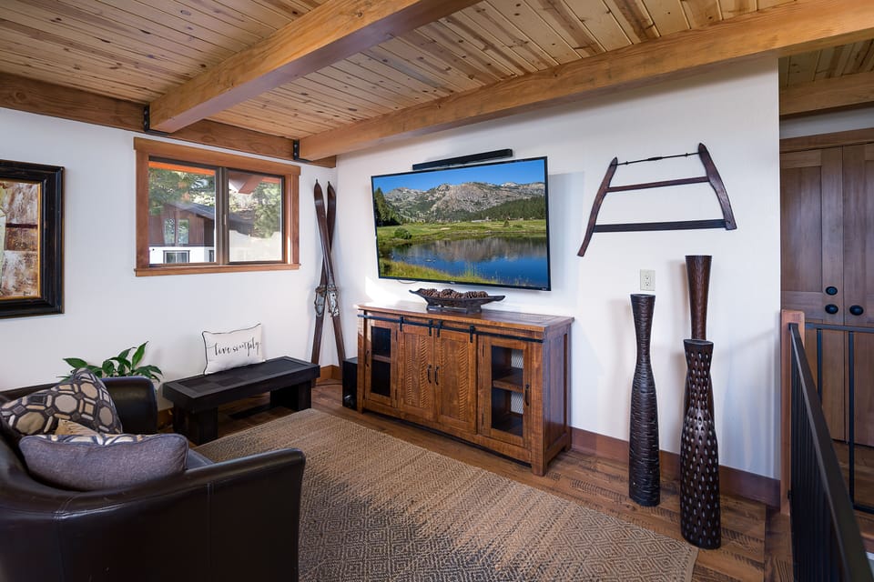 Another view of living area with flat screen TV to right of fireplace