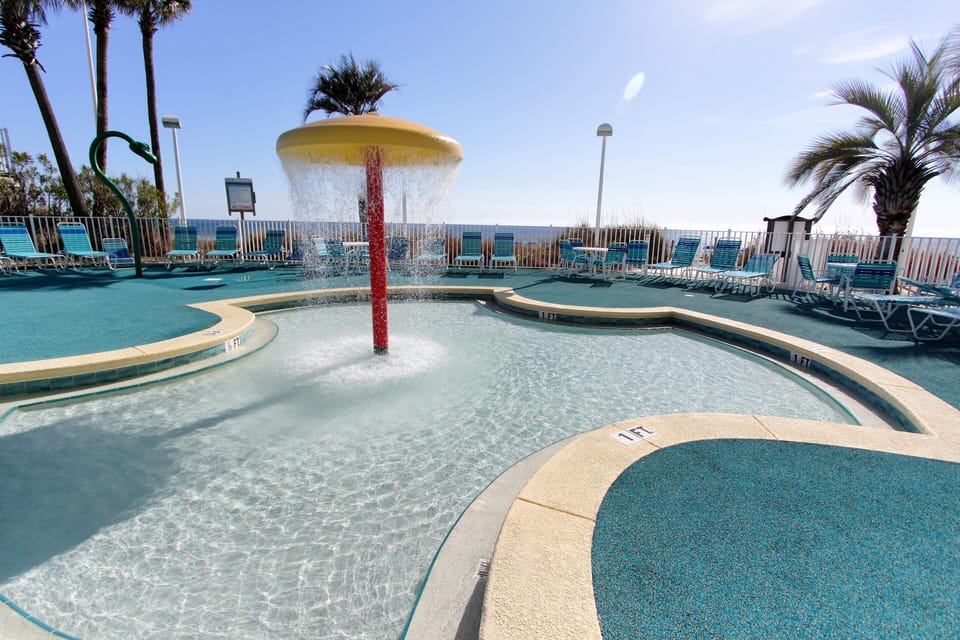 Splash pad - plenty of chairs for watching the little ones. Deck is soft rubber.