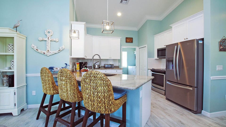 Kitchen with breakfast bar for another 3. All the small appliances you need.