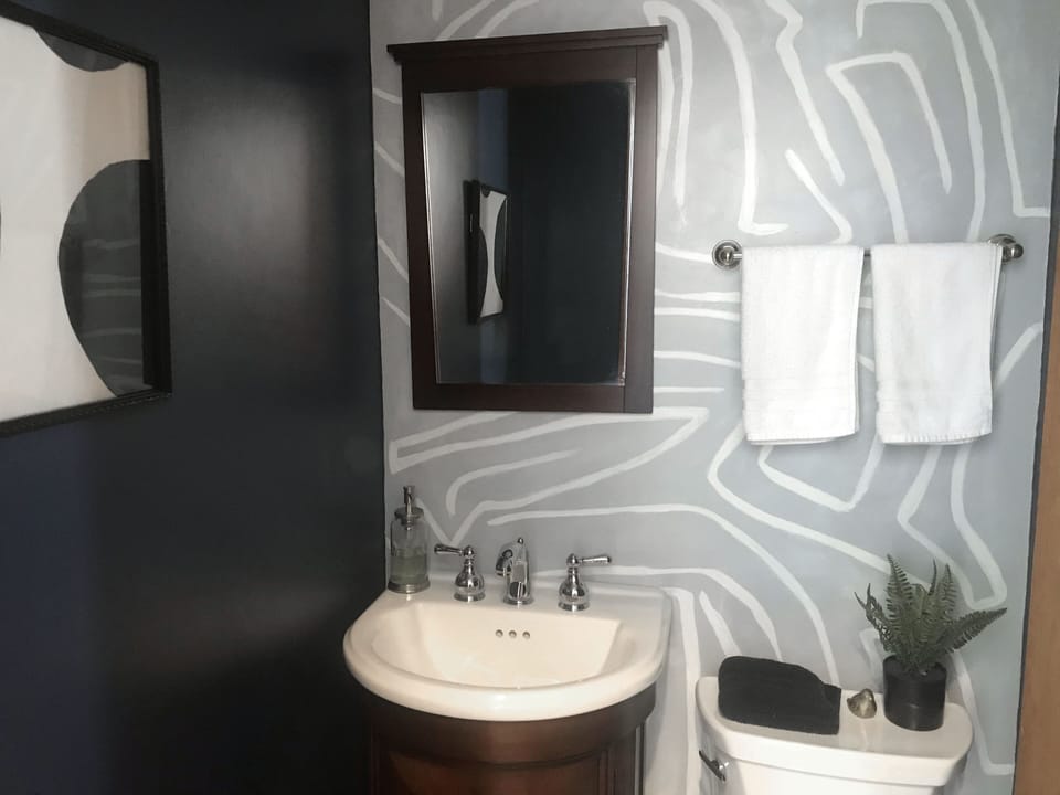 Half bath off entrance hallway, adjacent to kitchen and dining rooms.