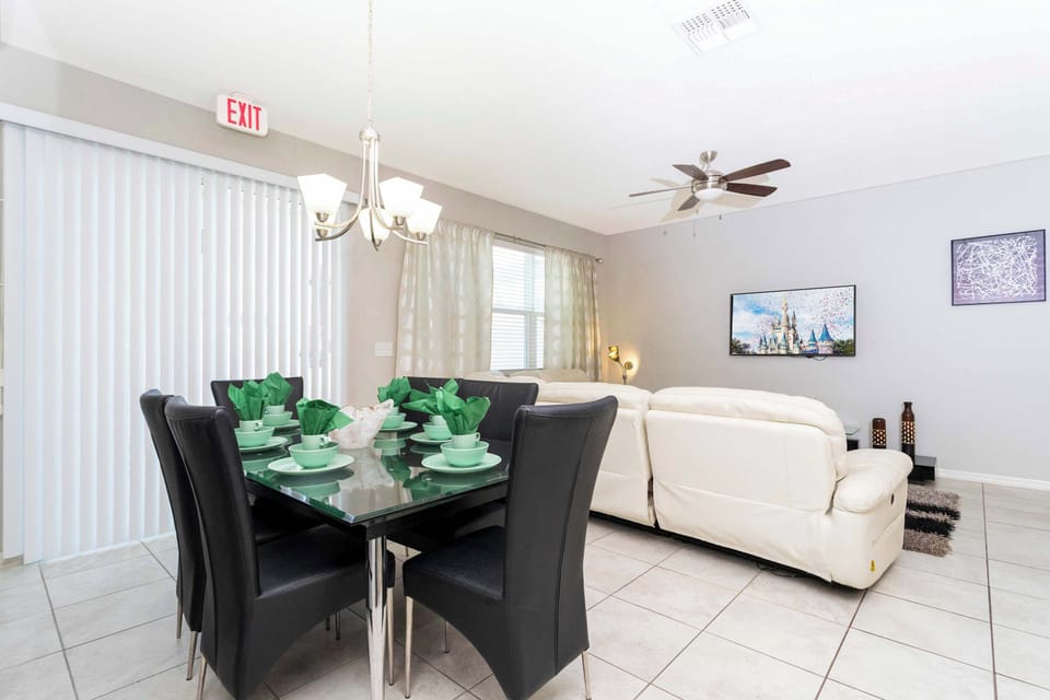 Bright, airy living room with a white sectional and large windows-calm, comfortable, and ideal for downtime.