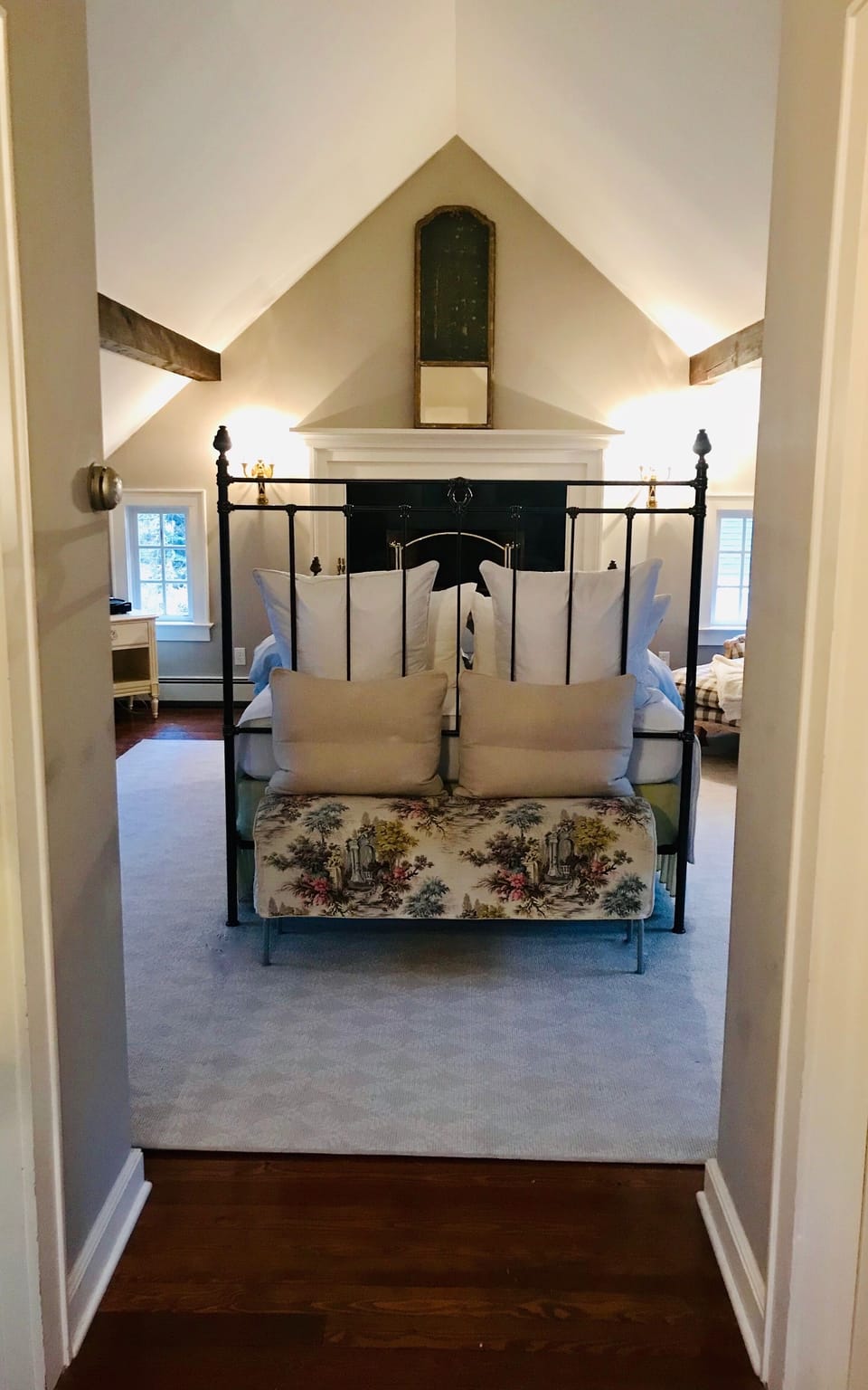 Bedroom suite 1 with queen bed and decorative fireplace