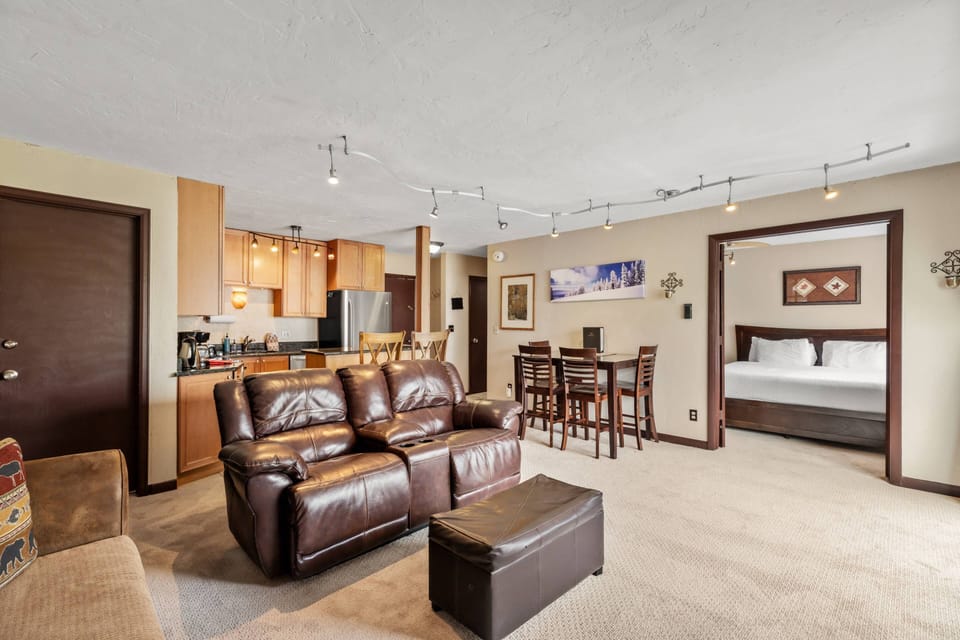 Cozy mountain vibes with a stone fireplace, plush seating, and natural light—your perfect hangout spot.