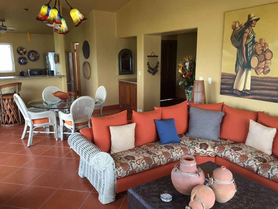 Large living, dining, kitchen area with Mexican tiled floors throughout