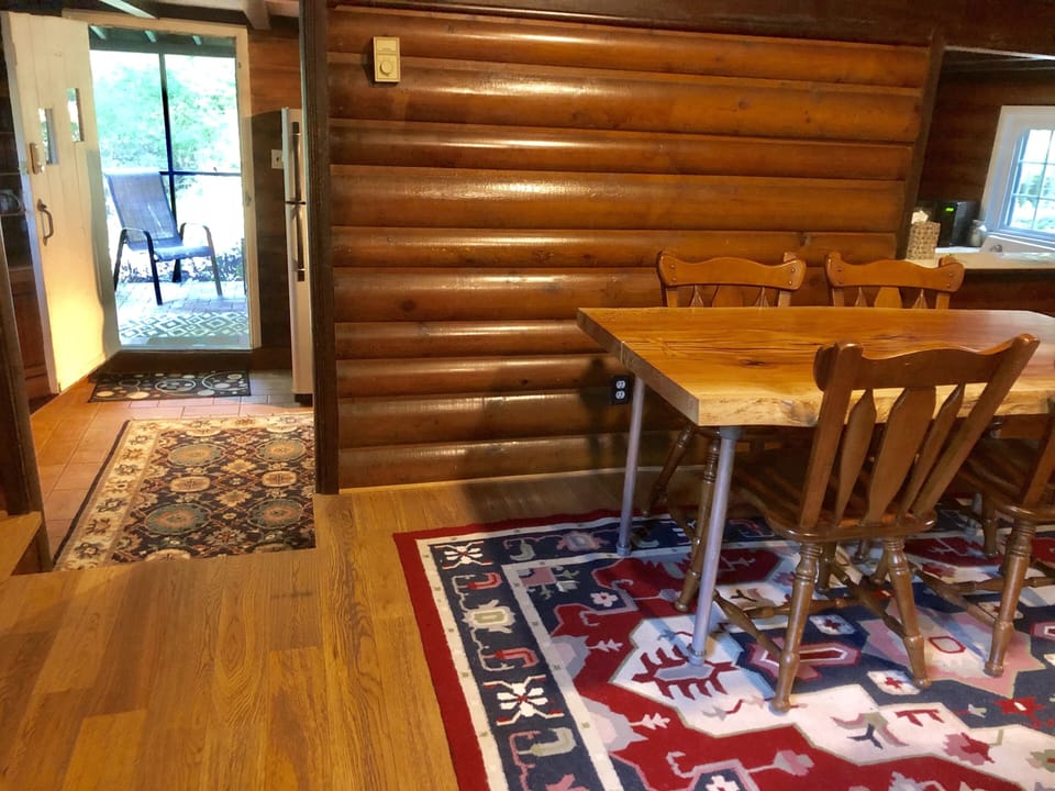 Steps leading down into the kitchen from Living Rm. Larger screened-in porch