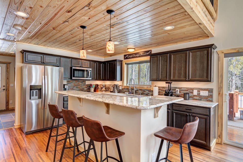 Bar seating for four to nibble or visit while the cook is in the kitchen.