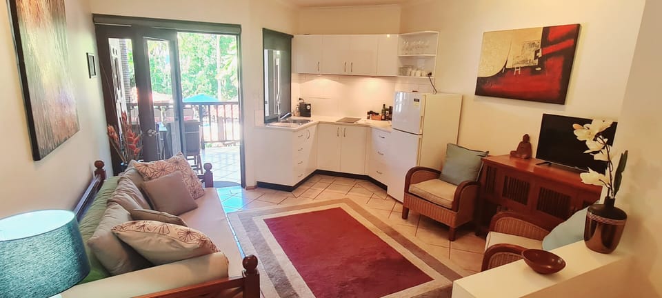 The lounge room leads out to the private balcony overlooking the pool.