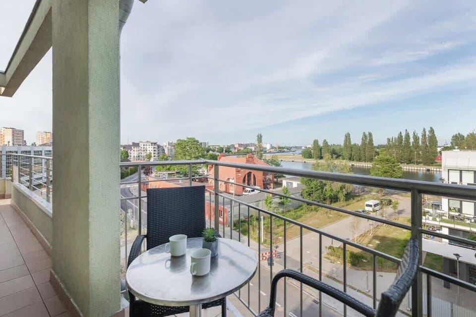 A balcony view showing greenery and a peaceful urban area.