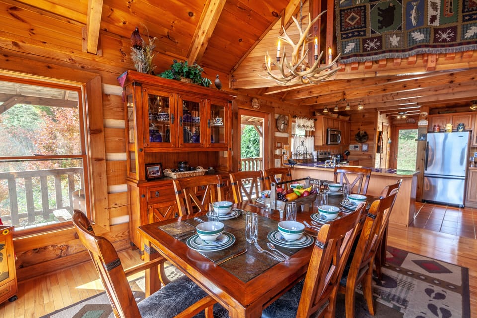Dining Area Features Banquet-Style Seating for 8, an Antler Chandelier, Mountain Views, and Lots of Natural Light